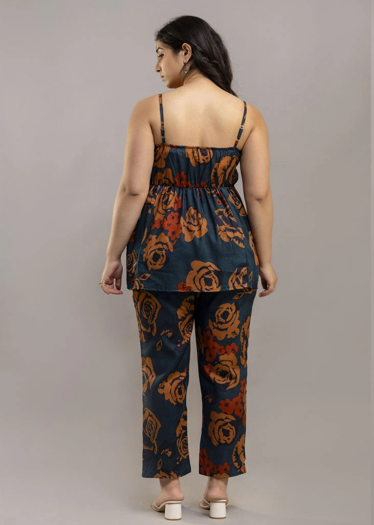 Women’s rust and teal floral co-ord set with a sleeveless spaghetti strap top and matching premium rayon pants — lightweight, stylish, and perfect for warm-weather wear.