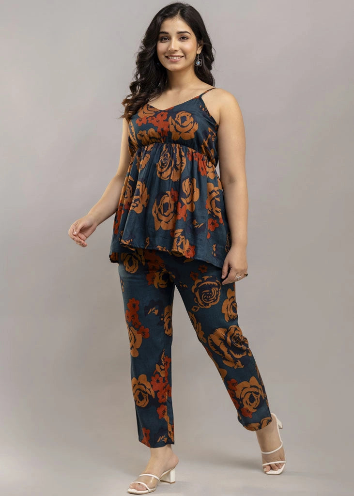 Women’s rust and teal floral co-ord set with a sleeveless spaghetti strap top and matching premium rayon pants — lightweight, stylish, and perfect for warm-weather wear.