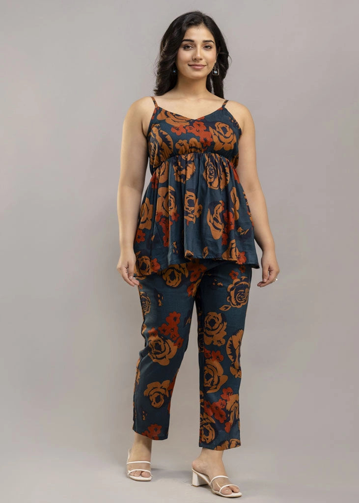 Women’s rust and teal floral co-ord set with a sleeveless spaghetti strap top and matching premium rayon pants — lightweight, stylish, and perfect for warm-weather wear.