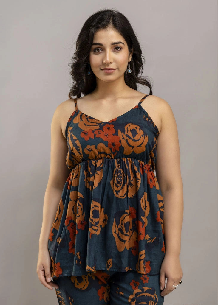 Women’s rust and teal floral co-ord set with a sleeveless spaghetti strap top and matching premium rayon pants — lightweight, stylish, and perfect for warm-weather wear.