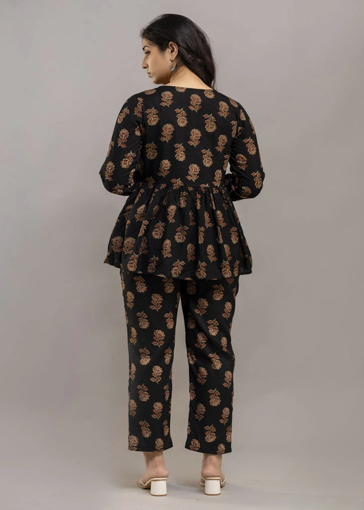 Women’s black co-ord set in soft rayon, featuring rustic floral prints, a full-sleeve flared top with a relaxed silhouette, and matching straight-fit pants — combining effortless elegance with everyday comfort.