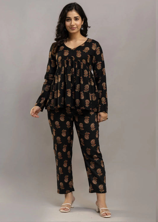 Women’s black co-ord set in soft rayon, featuring rustic floral prints, a full-sleeve flared top with a relaxed silhouette, and matching straight-fit pants — combining effortless elegance with everyday comfort.