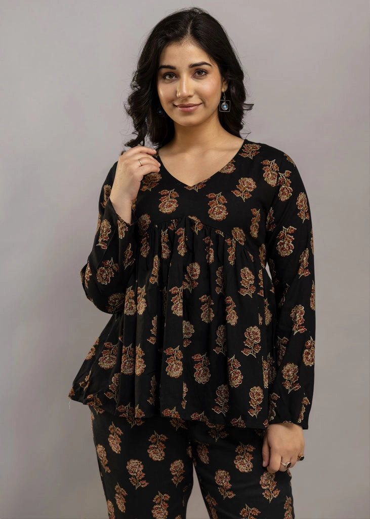 Women’s black co-ord set in soft rayon, featuring rustic floral prints, a full-sleeve flared top with a relaxed silhouette, and matching straight-fit pants — combining effortless elegance with everyday comfort.