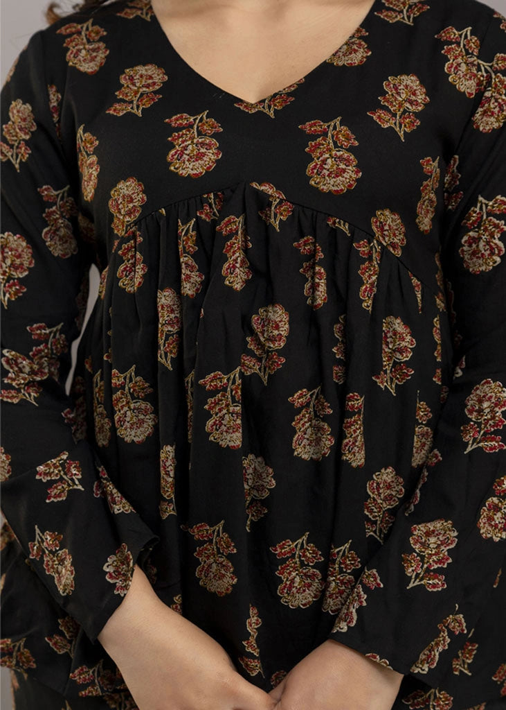 Women’s black co-ord set in soft rayon, featuring rustic floral prints, a full-sleeve flared top with a relaxed silhouette, and matching straight-fit pants — combining effortless elegance with everyday comfort.