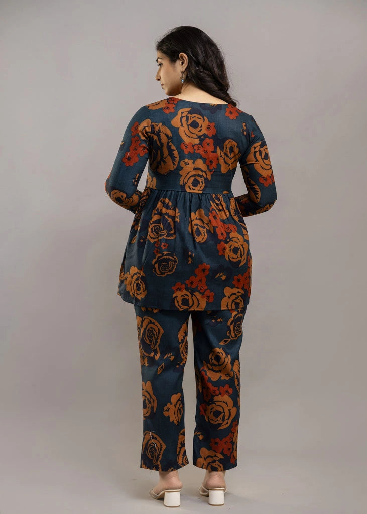 Women’s teal and rust floral printed co-ord set in premium rayon, featuring a flowy gathered top with relaxed flared full sleeves and matching straight-fit pants — a soft, breathable outfit that blends bold style with everyday comfort.