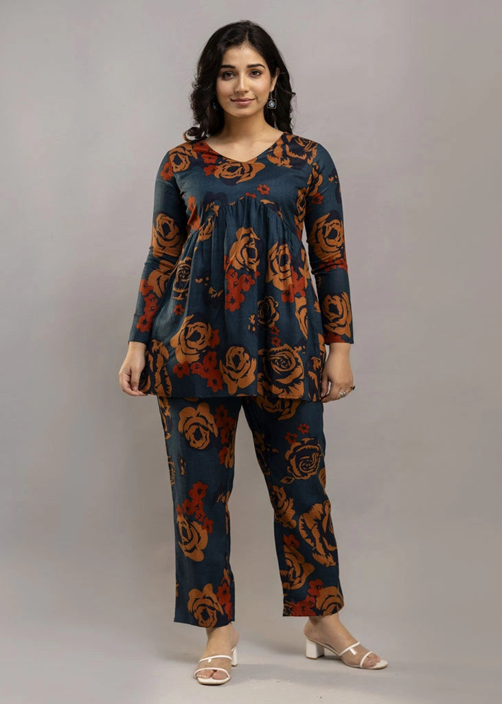 Women’s teal and rust floral printed co-ord set in premium rayon, featuring a flowy gathered top with relaxed flared full sleeves and matching straight-fit pants — a soft, breathable outfit that blends bold style with everyday comfort.