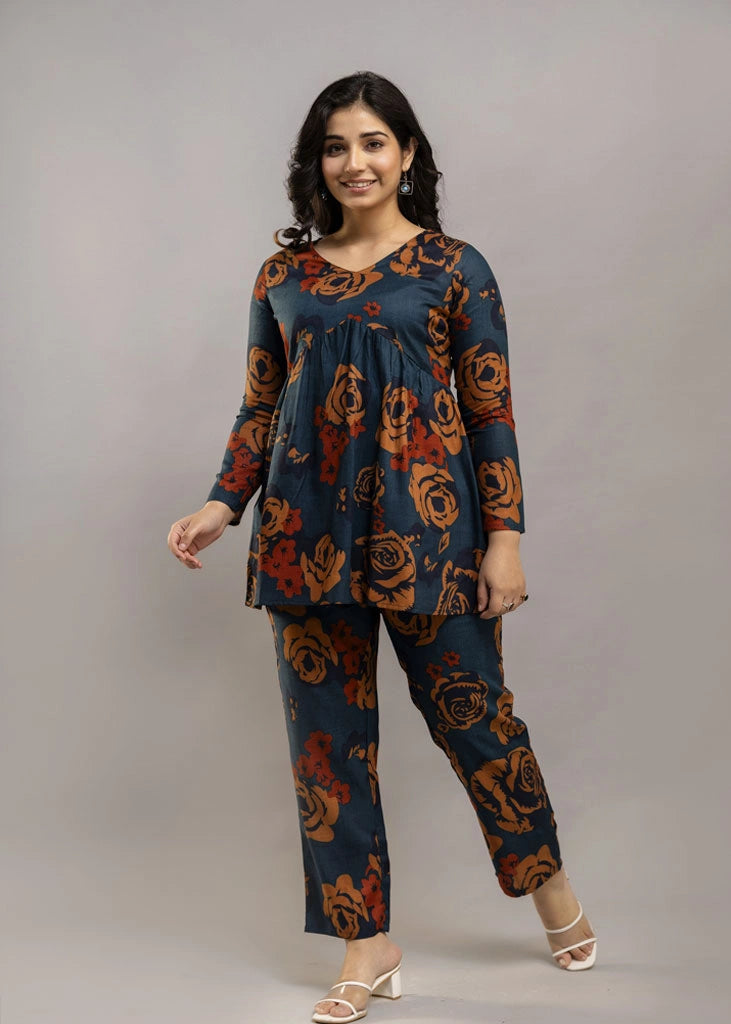 Women’s teal and rust floral printed co-ord set in premium rayon, featuring a flowy gathered top with relaxed flared full sleeves and matching straight-fit pants — a soft, breathable outfit that blends bold style with everyday comfort.