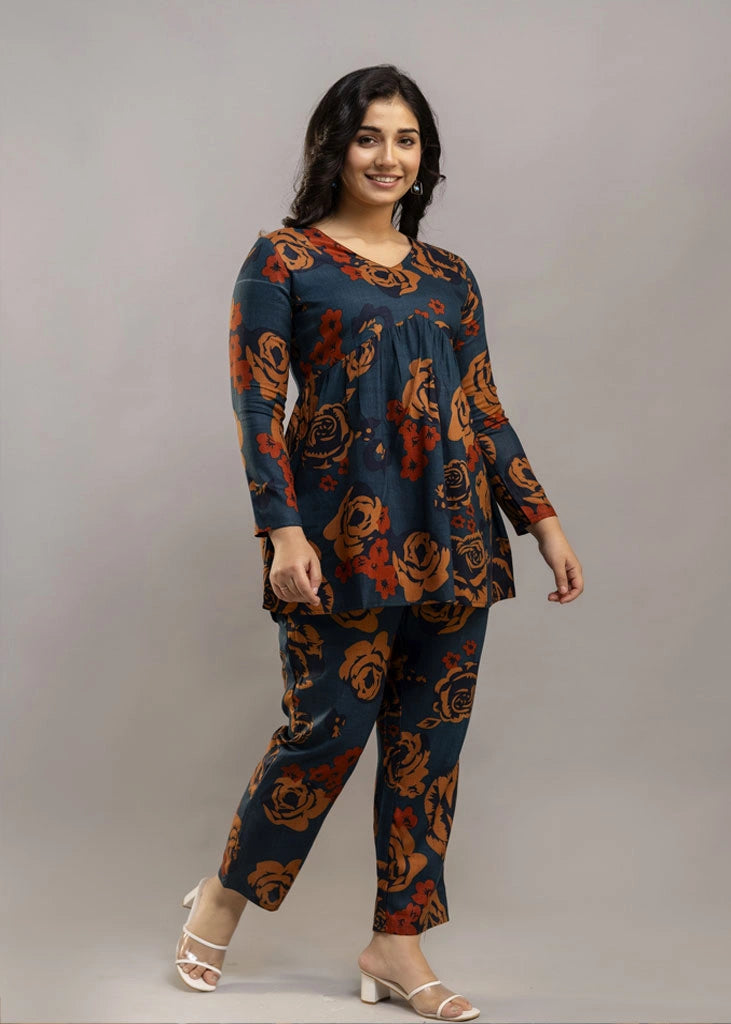 Women’s teal and rust floral printed co-ord set in premium rayon, featuring a flowy gathered top with relaxed flared full sleeves and matching straight-fit pants — a soft, breathable outfit that blends bold style with everyday comfort.