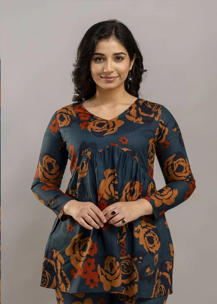 Women’s teal and rust floral printed co-ord set in premium rayon, featuring a flowy gathered top with relaxed flared full sleeves and matching straight-fit pants — a soft, breathable outfit that blends bold style with everyday comfort.
