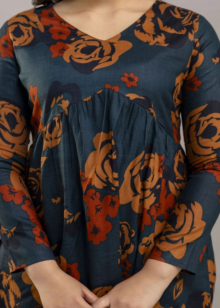 Women’s teal and rust floral printed co-ord set in premium rayon, featuring a flowy gathered top with relaxed flared full sleeves and matching straight-fit pants — a soft, breathable outfit that blends bold style with everyday comfort.