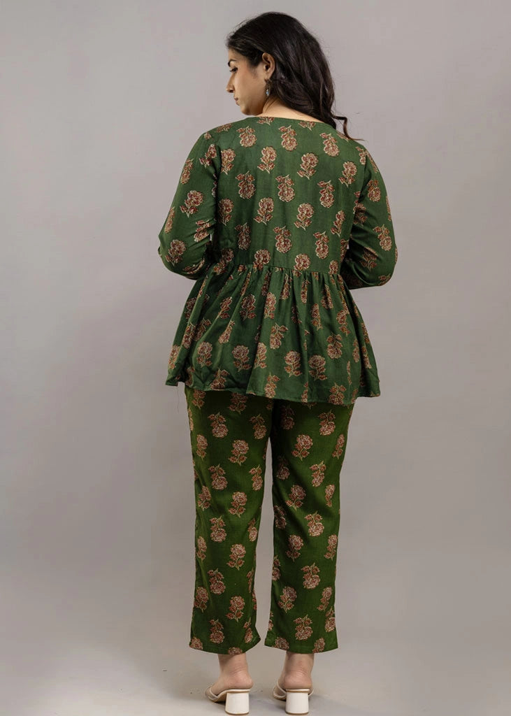 Women’s forest green floral printed co-ord set in premium rayon, featuring a gathered empire-line top with full sleeves and straight-fit pants with pockets — blending natural charm with everyday comfort.