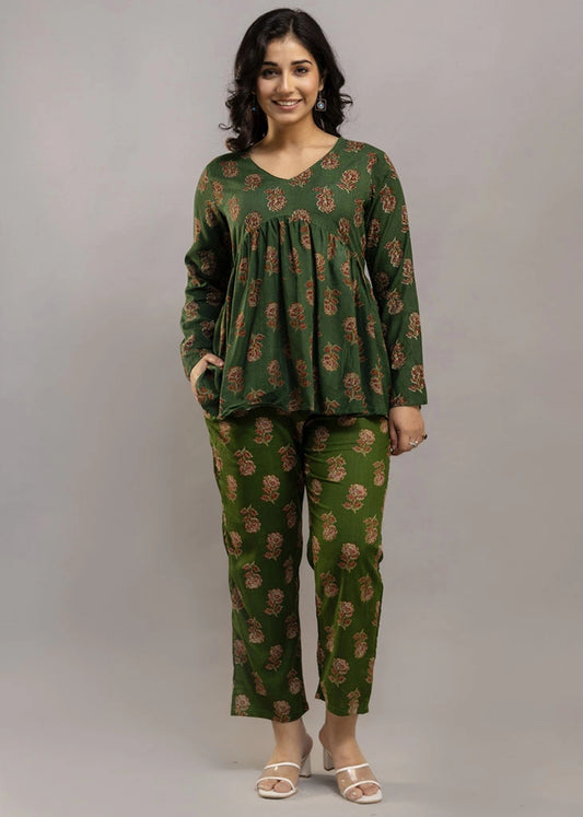 Women’s forest green floral printed co-ord set in premium rayon, featuring a gathered empire-line top with full sleeves and straight-fit pants with pockets — blending natural charm with everyday comfort.