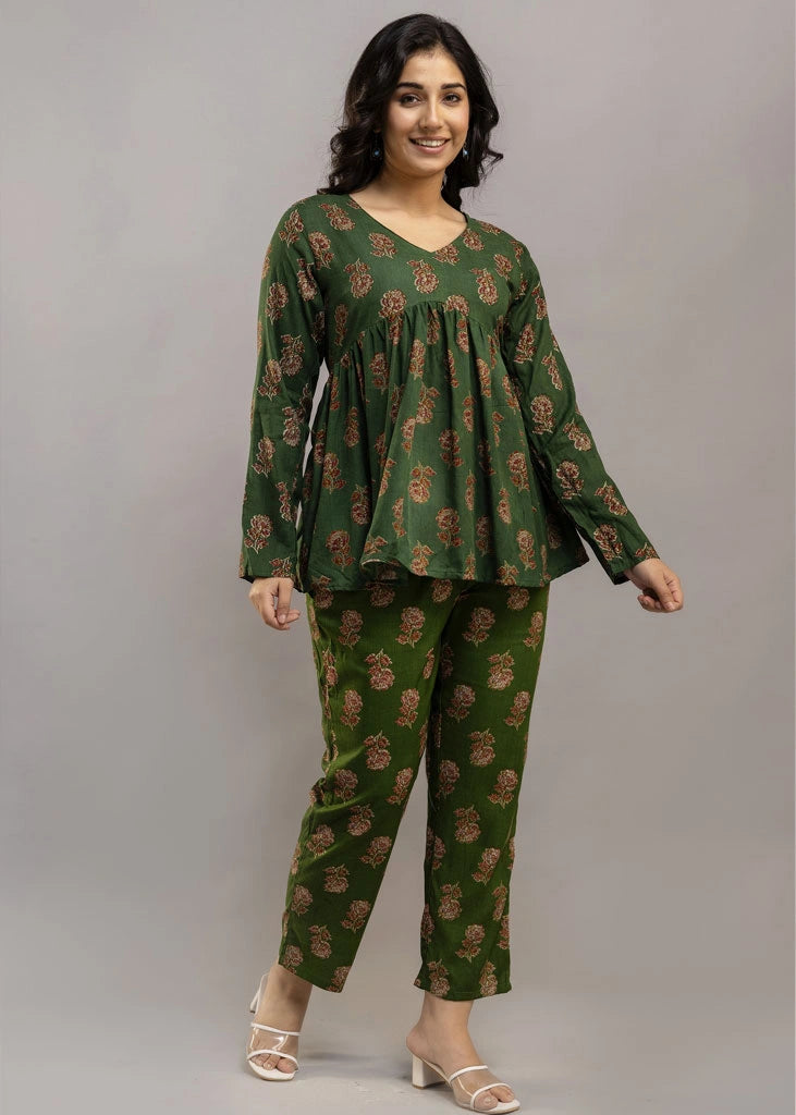 Women’s forest green floral printed co-ord set in premium rayon, featuring a gathered empire-line top with full sleeves and straight-fit pants with pockets — blending natural charm with everyday comfort.