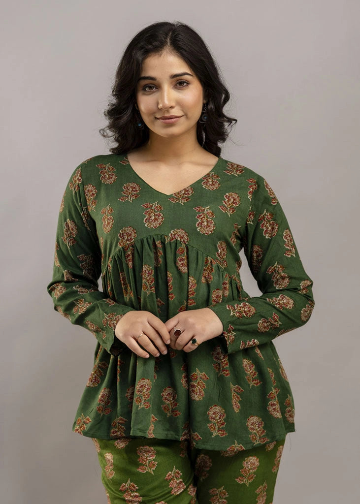 Women’s forest green floral printed co-ord set in premium rayon, featuring a gathered empire-line top with full sleeves and straight-fit pants with pockets — blending natural charm with everyday comfort.
