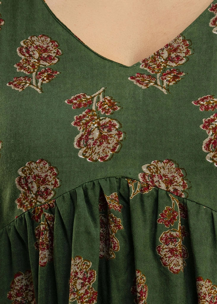 Women’s forest green floral printed co-ord set in premium rayon, featuring a gathered empire-line top with full sleeves and straight-fit pants with pockets — blending natural charm with everyday comfort.