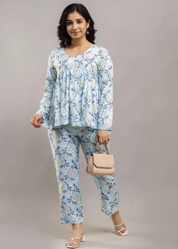 Women’s pastel blue leafy print co-ord set in soft rayon, featuring a gathered flowy top with a gentle V-neckline and full sleeves, paired with relaxed-fit pants with pockets — a blend of comfort and elegance for everyday wear.