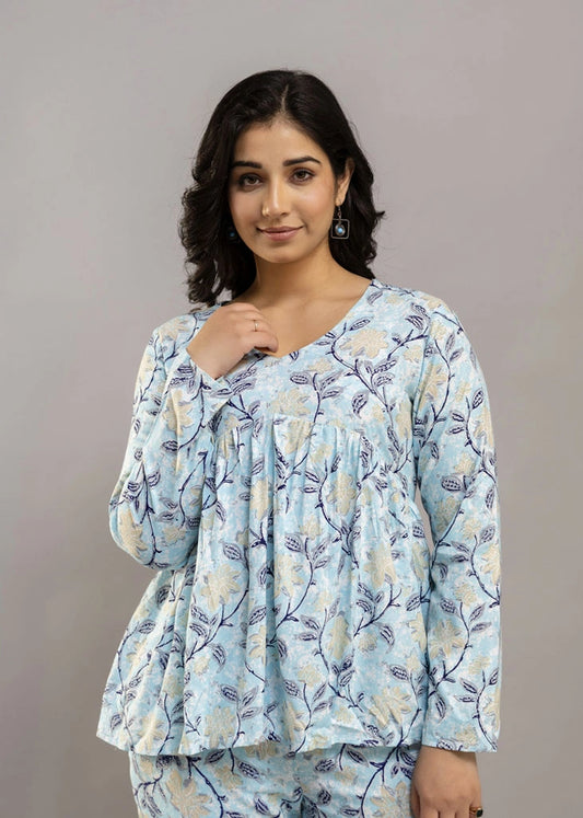Women’s pastel blue leafy print co-ord set in soft rayon, featuring a gathered flowy top with a gentle V-neckline and full sleeves, paired with relaxed-fit pants with pockets — a blend of comfort and elegance for everyday wear.