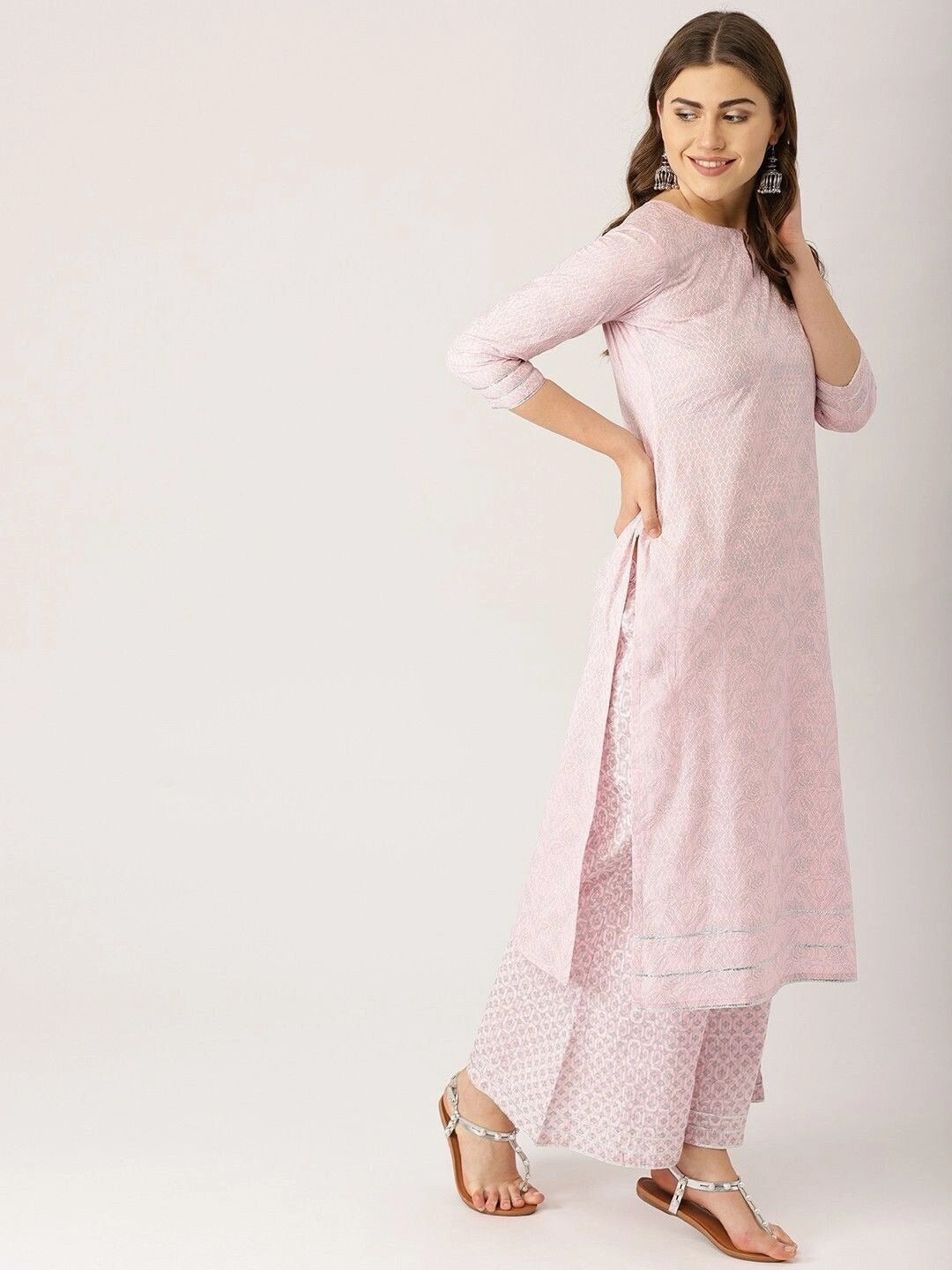 Women’s light pink ethnic motifs printed kurta set with silver gotta patti work, featuring a straight-fit kurta with keyhole neckline, three-quarter sleeves, flared palazzo pants, and a matching sheer dupatta.
