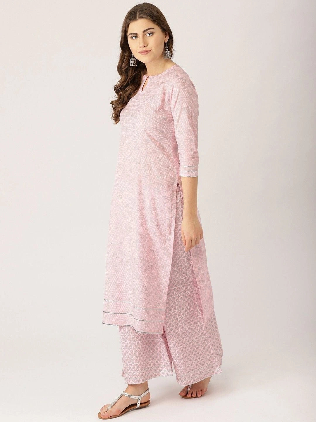 Women’s light pink ethnic motifs printed kurta set with silver gotta patti work, featuring a straight-fit kurta with keyhole neckline, three-quarter sleeves, flared palazzo pants, and a matching sheer dupatta.