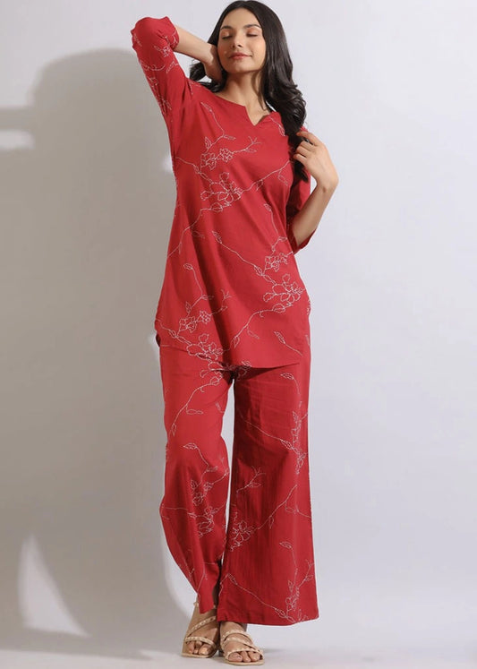 Women’s Orange floral printed co-ord set in pure cotton, featuring a round-neck tunic with three-quarter sleeves and matching printed trousers with an elasticated slip-on waistband — lightweight, breathable, and perfect for casual wear.