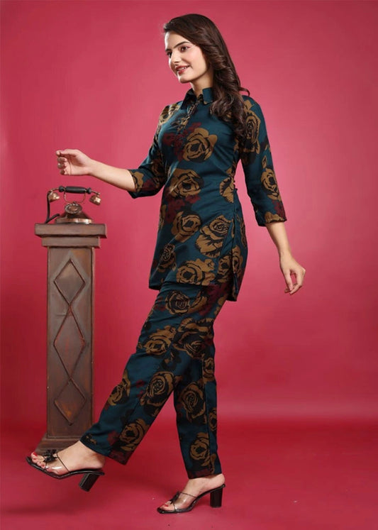 Women’s blue viscose rayon co-ord set featuring a collared top with 3/4 sleeves and vibrant yellow and red floral embroidery, paired with matching pants — a breezy, elegant outfit for casual or semi-formal wear.