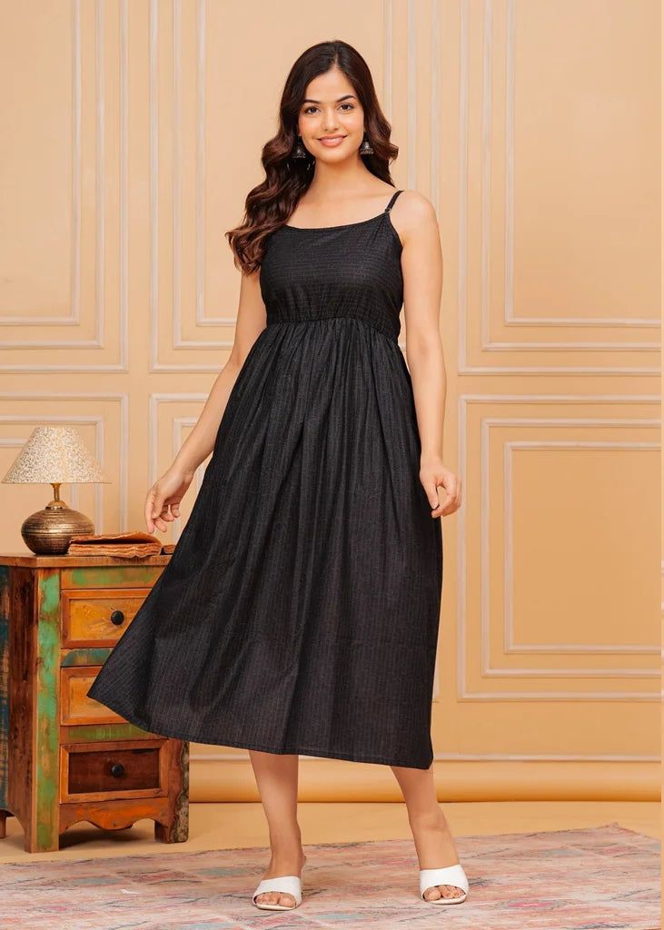 Sleeveless black maxi dress for women, featuring a flared floor‑length silhouette with a square neckline and airy drape, crafted from lightweight fabric for an elegant, flowing fit.