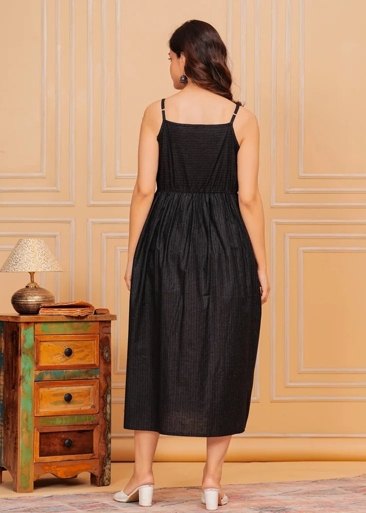 Sleeveless black maxi dress for women, featuring a flared floor‑length silhouette with a square neckline and airy drape, crafted from lightweight fabric for an elegant, flowing fit.
