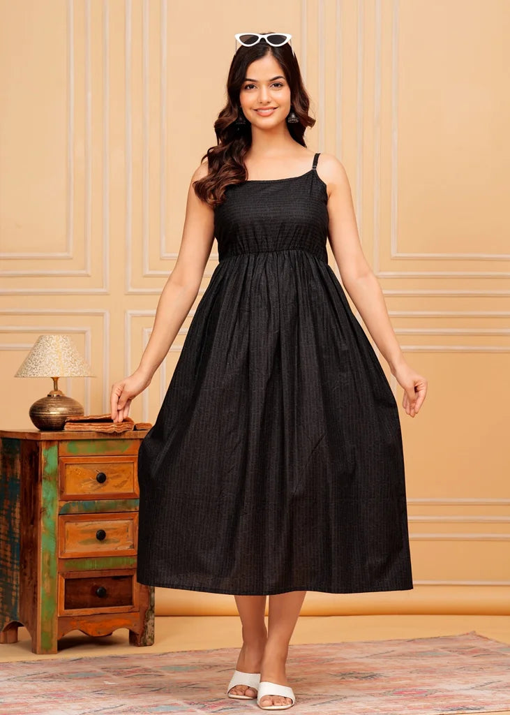 Sleeveless black maxi dress for women, featuring a flared floor‑length silhouette with a square neckline and airy drape, crafted from lightweight fabric for an elegant, flowing fit.
