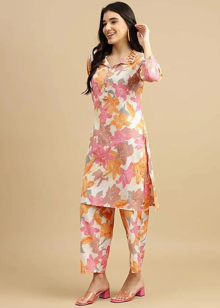 Women's pink cotton kurti and pant set with embroidered detailing and three-quarter sleeves