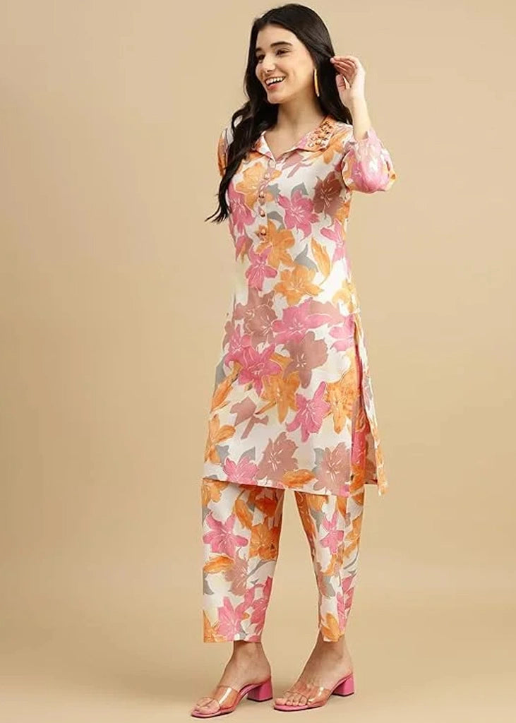 Women's pink cotton kurti and pant set with embroidered detailing and three-quarter sleeves