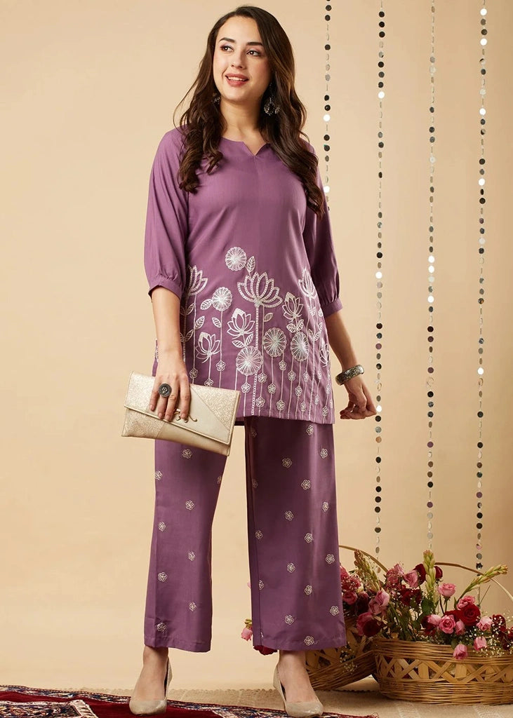 Women's lavender  kurta-and-pant set in lightweight fabric, featuring intricate white floral embroidery across the front, with a round neckline, three-quarter sleeves, straight pants, and a streamlined, elegant silhouette.