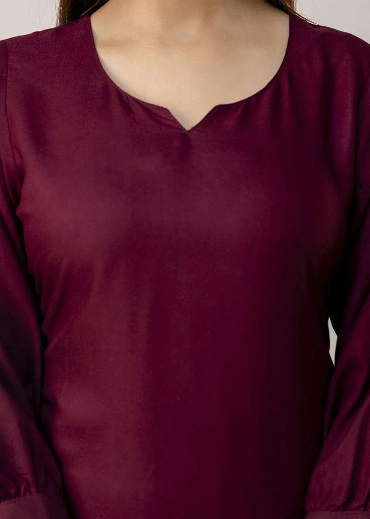 Women's Maroon kurta-and-pant set in lightweight fabric, featuring intricate white floral embroidery across the front, with a round neckline, three-quarter sleeves, straight pants, and a streamlined, elegant silhouette.